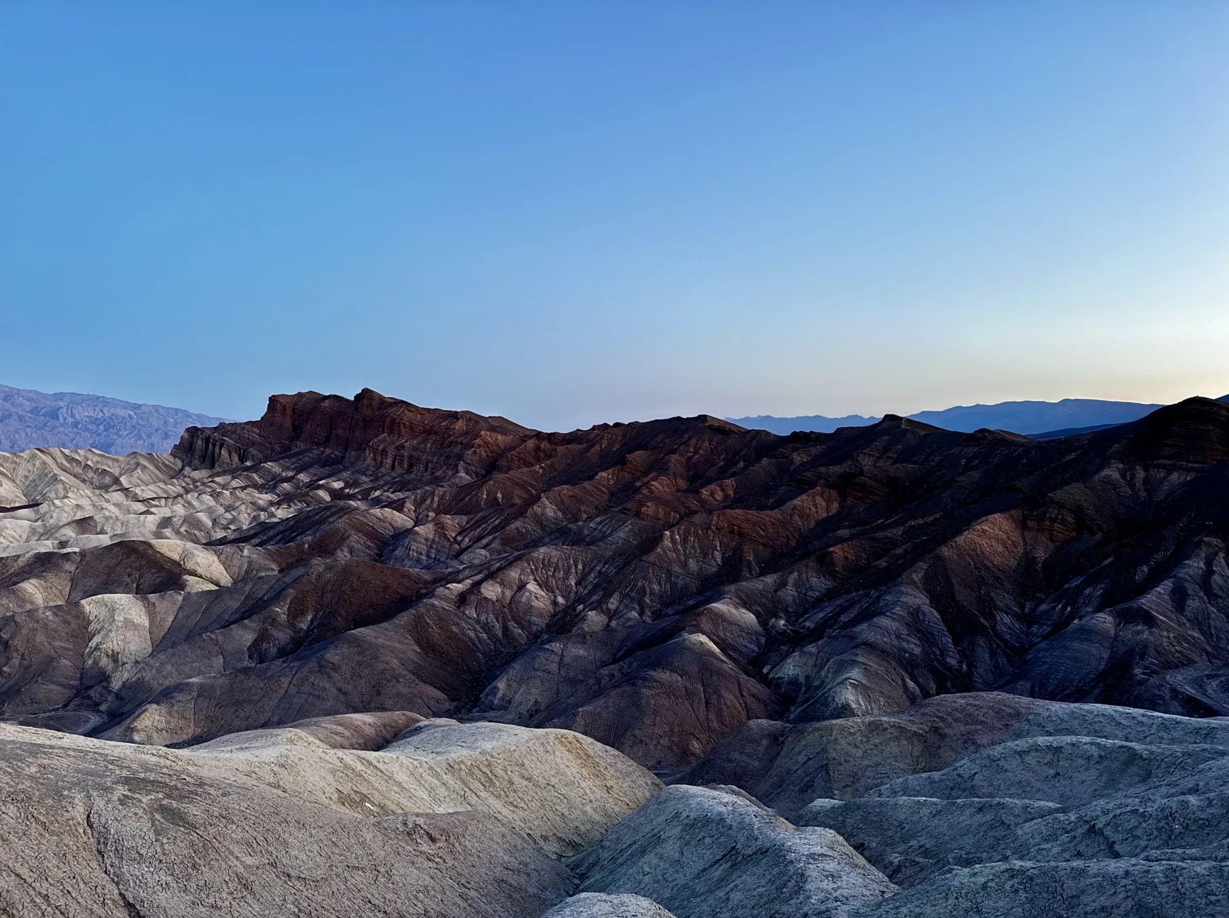 A mountain ridgeline at dusk, Austin Hunt's own photograph and the source of the Hunt Wealth palette