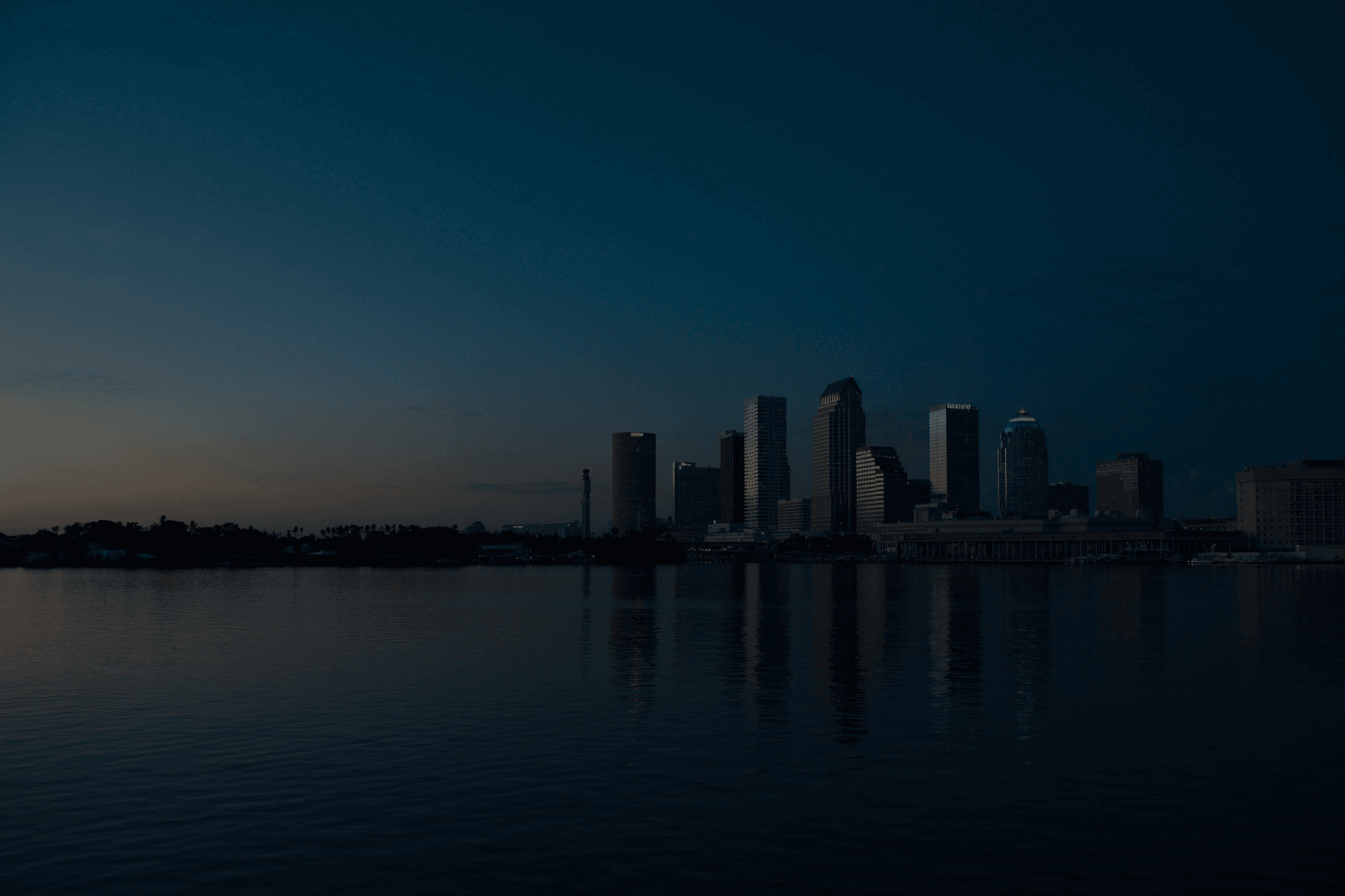 Downtown Tampa skyline across Hillsborough Bay at dusk